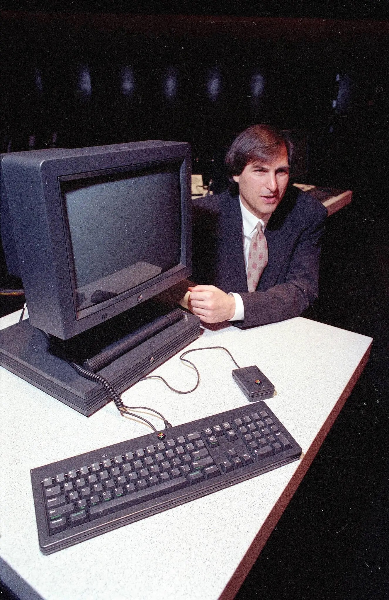 Steve Jobs behind a NeXT Station, photo by Eric Risberg Associated Press